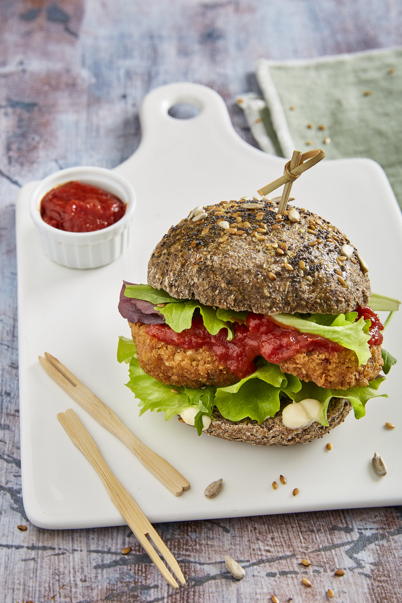 Falafel burger with salad, spicy tomato sauce (Passata) and lemon tahini