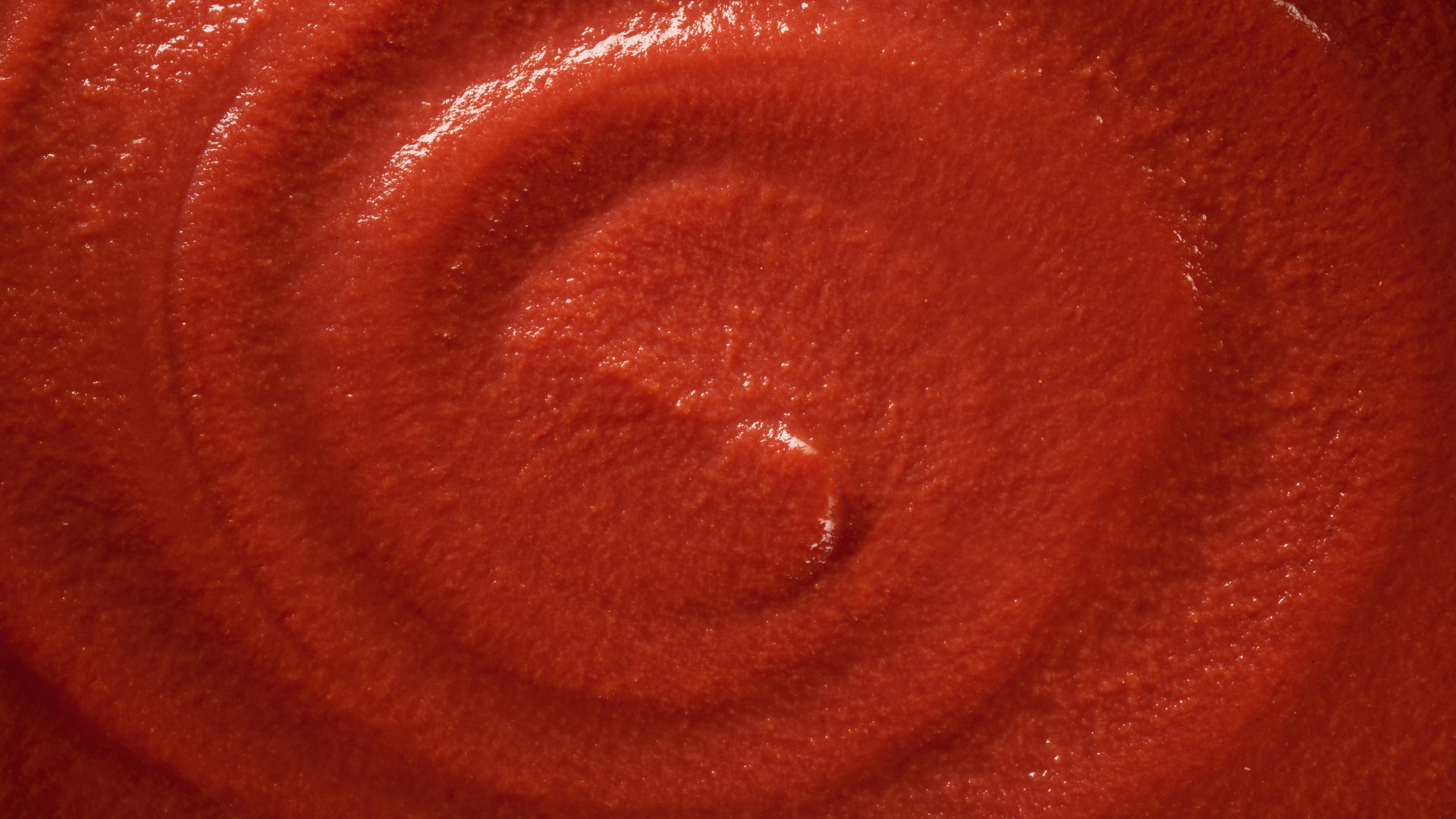 Close-up swirled texture of Mutti tomato purée