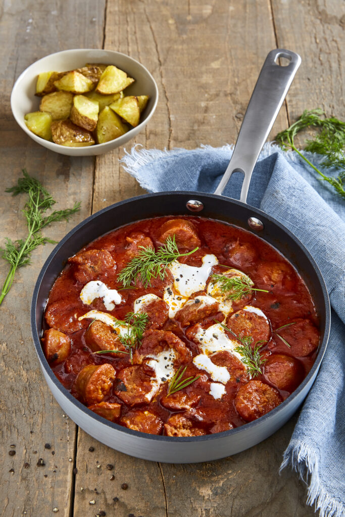 Sausage stew and potatoes with dill and sour cream