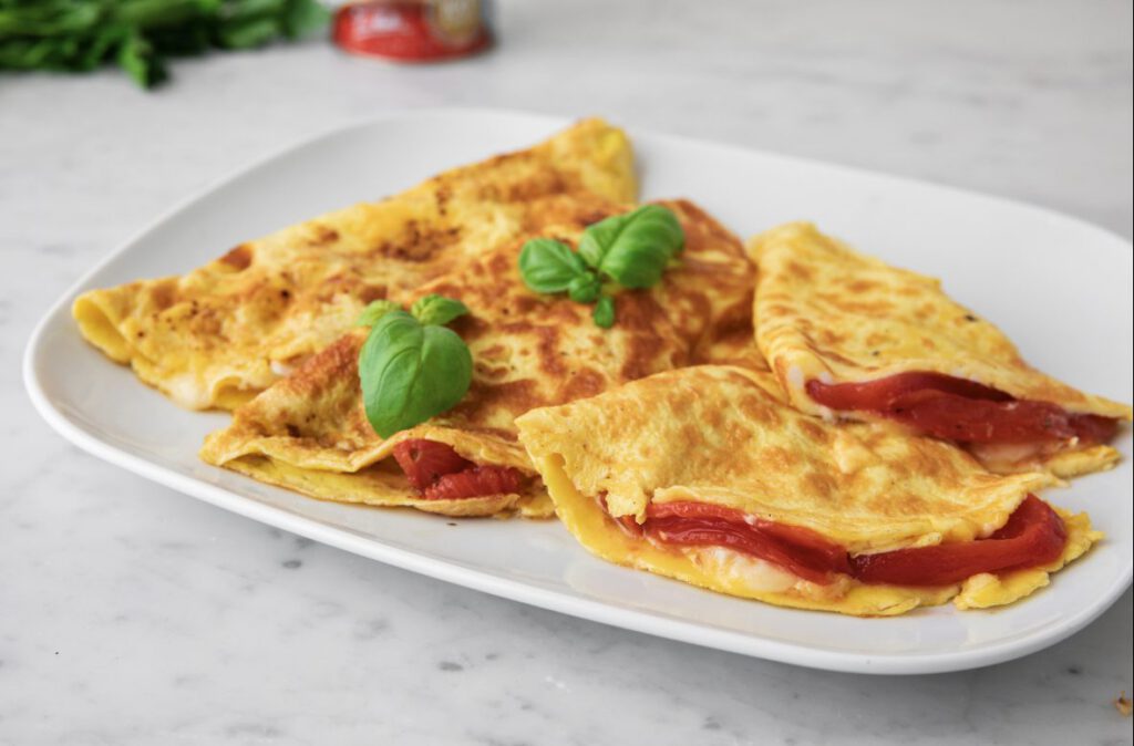 Omelette with brie cheese and marinated peeled tomatoes