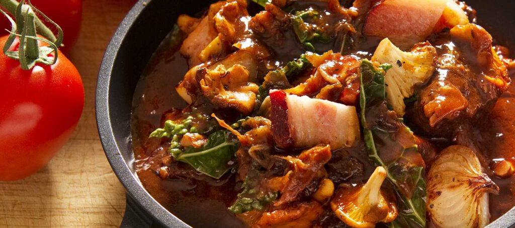 Autumn casserole with bacon, black kale and chanterelles