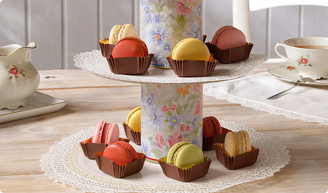 Tiered stand of macarons served with tea on a table
