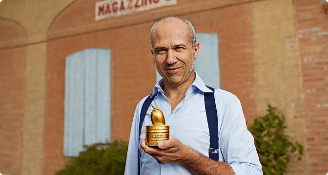 Farmer holding the golden Pomodorino d'Oro trophy outside a warehouse