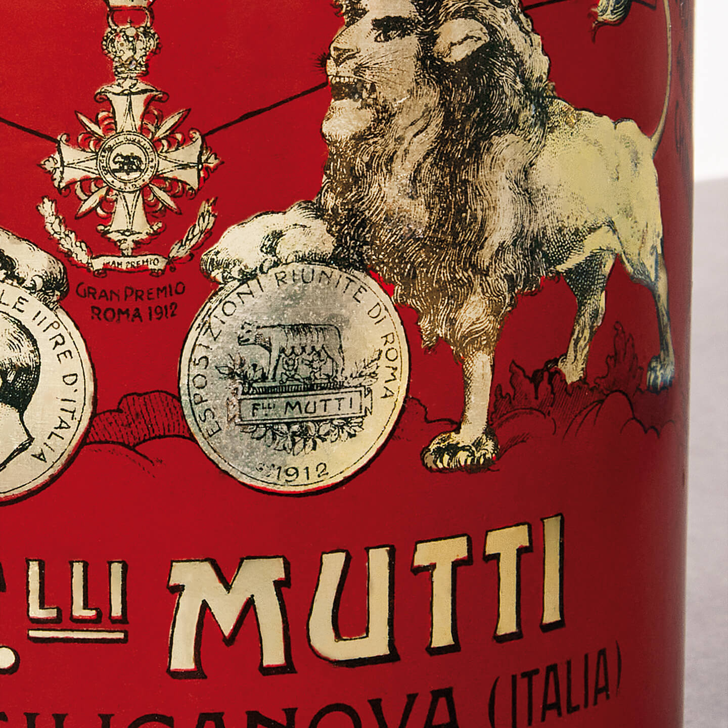 Close-up of a vintage Mutti tin can with lion and medal illustrations