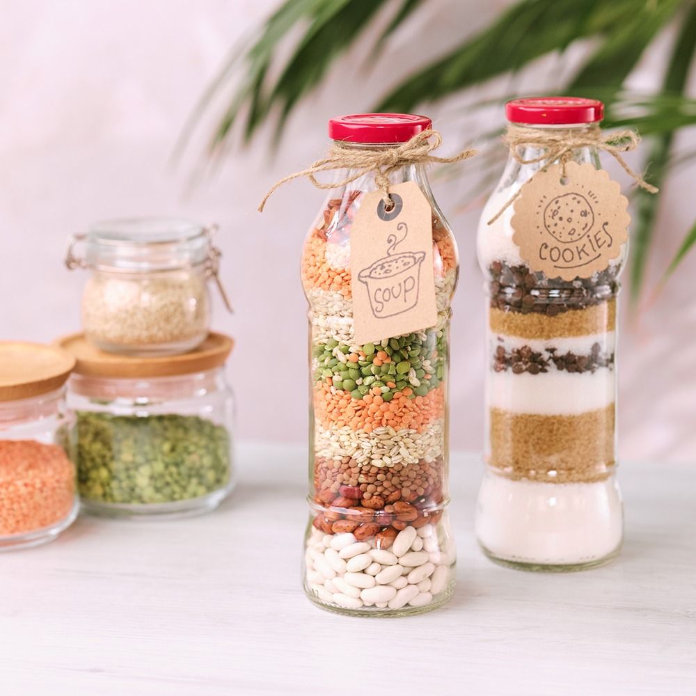 Layered soup and cookie ingredients in glass jars with recipe tags
