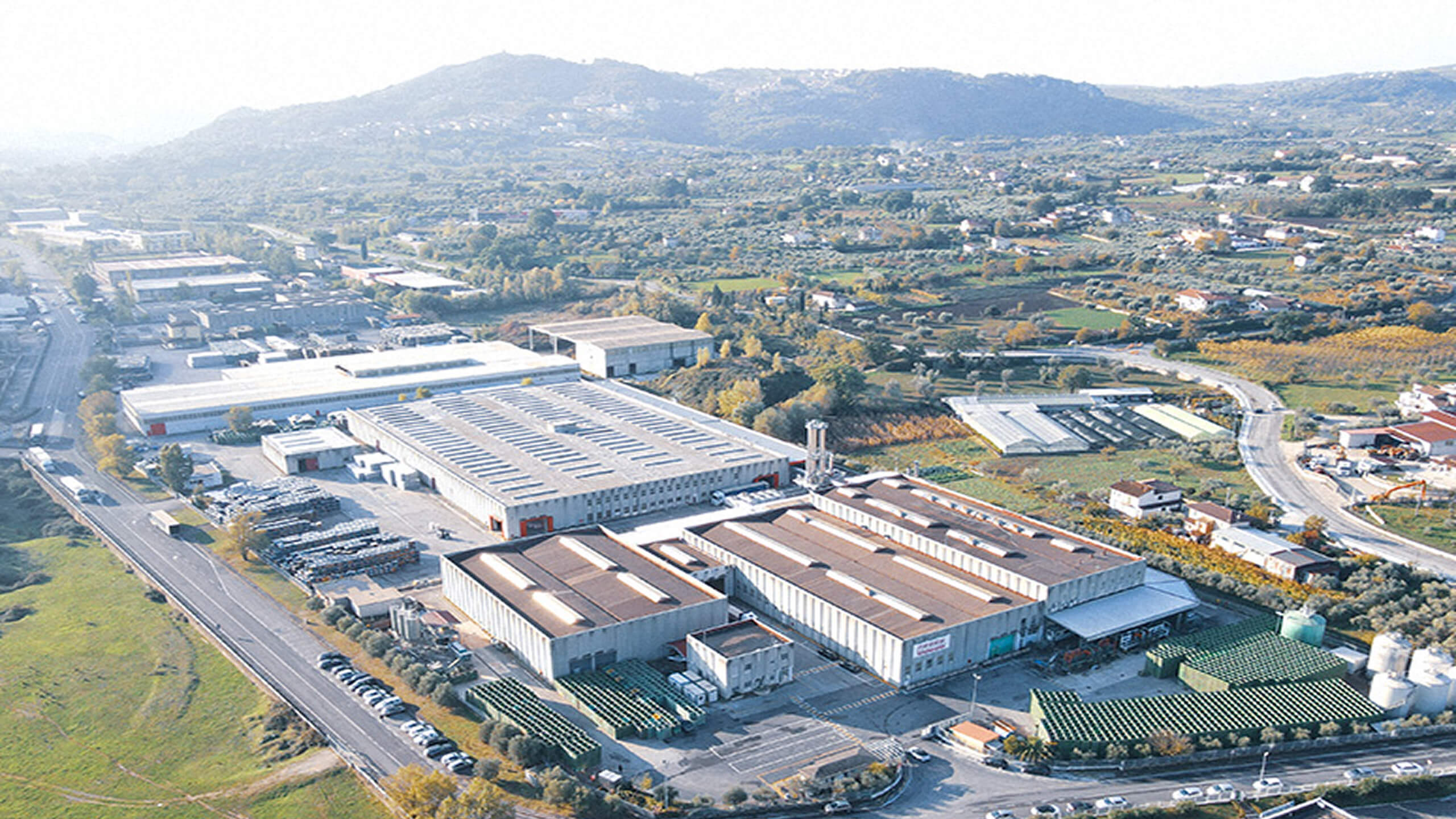 Aerial view of the Mutti factory site with surrounding hills