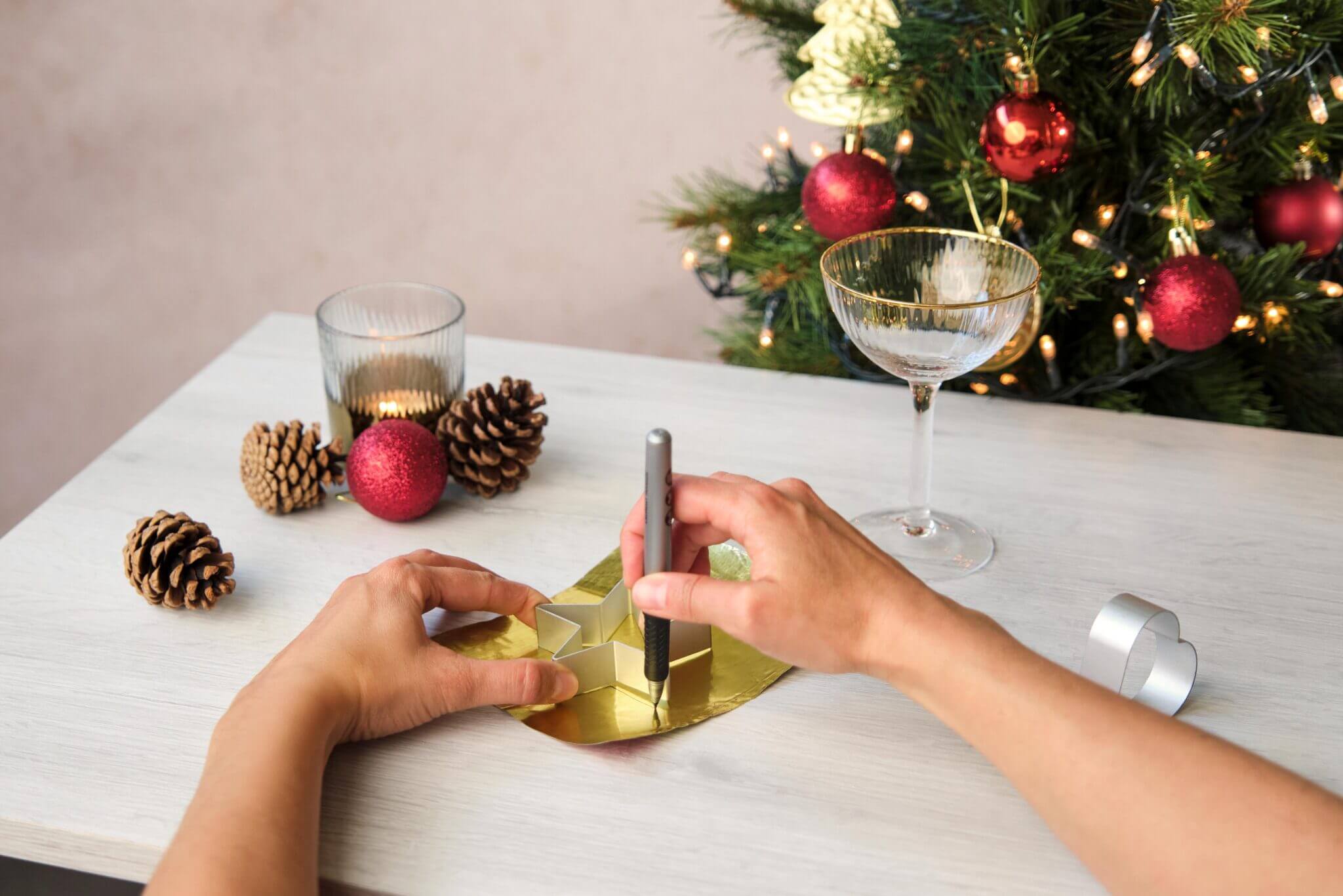 Smoothing a gold foil sheet with a yellow scraper