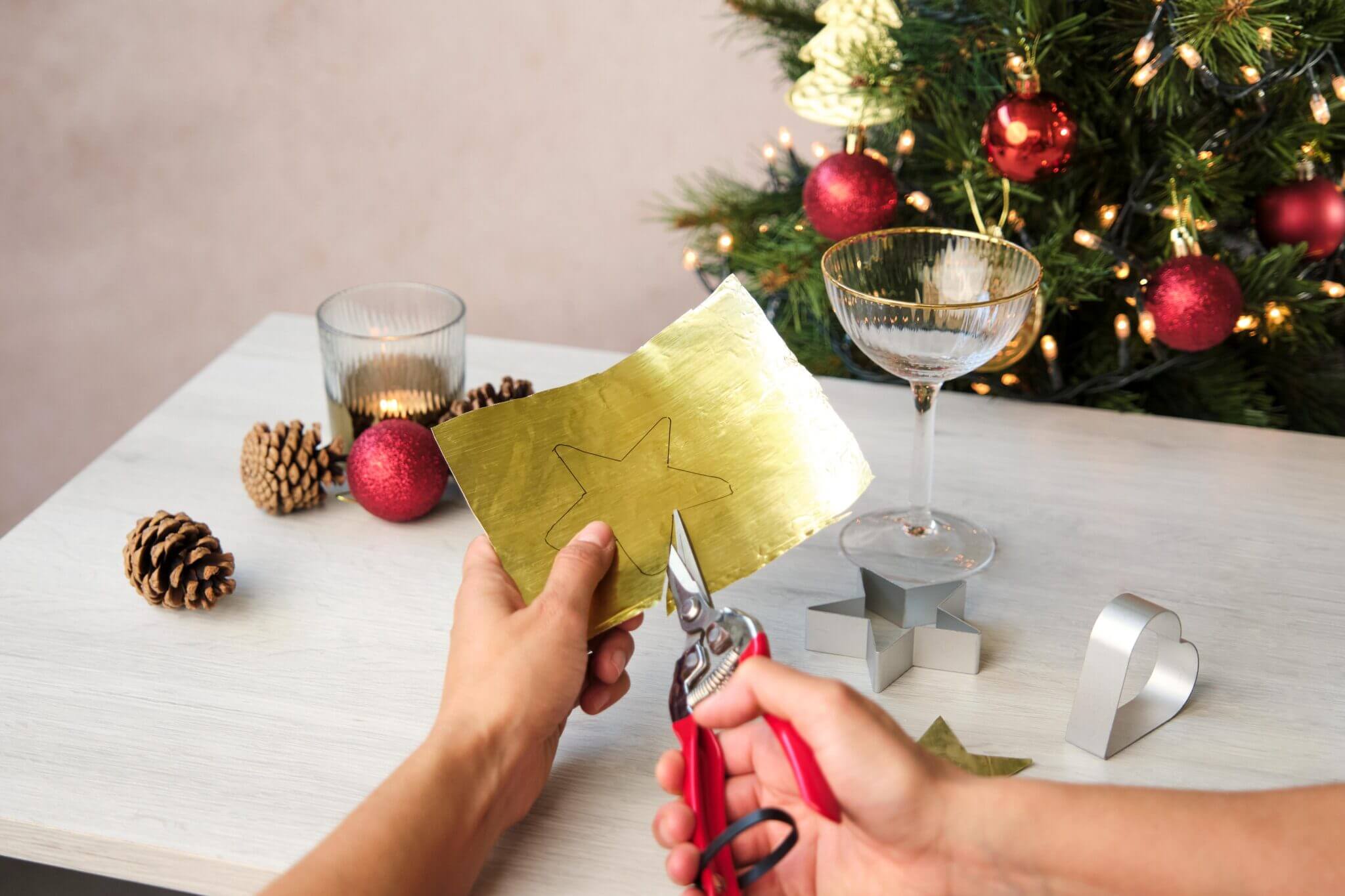 Drawing a star outline onto gold foil with a pen