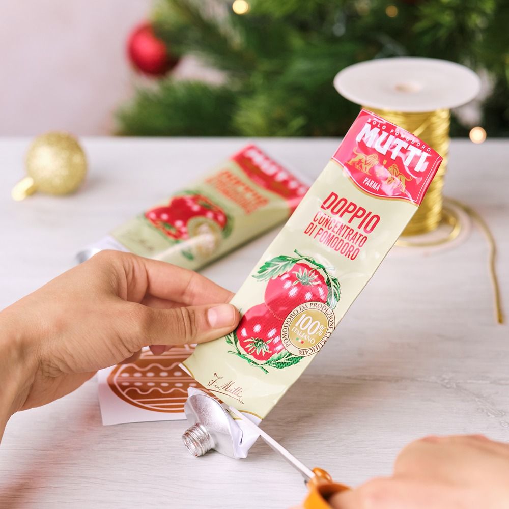 Cutting the cap off a Mutti Double Concentrated Tomato Paste tube