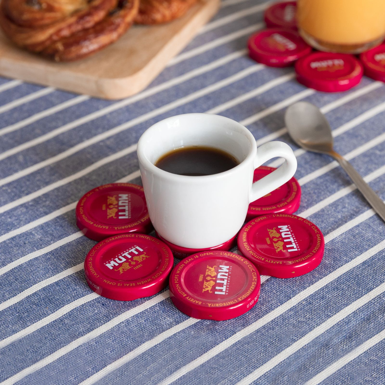 Coffee cup resting on a coaster made from Mutti bottle caps