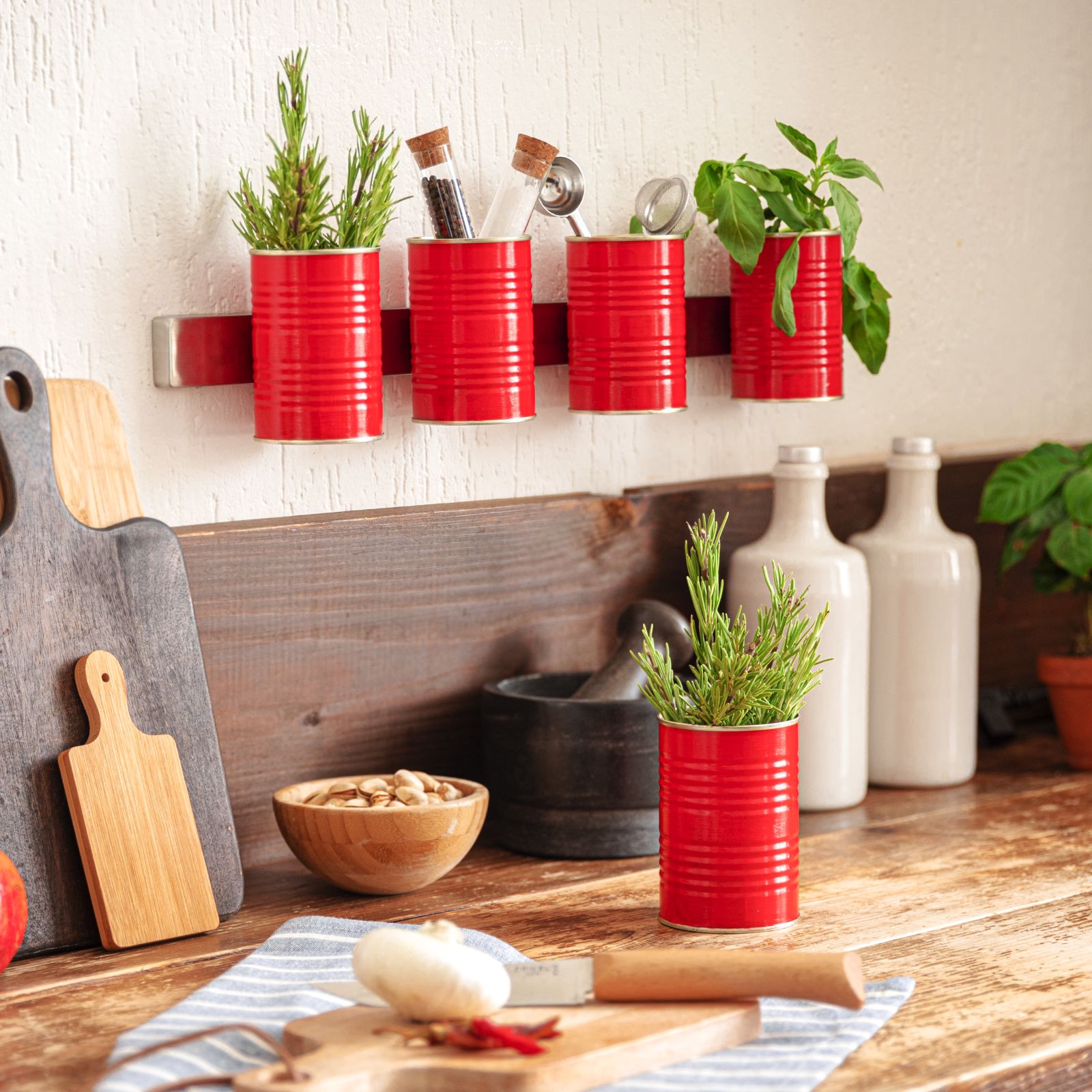 Mutti cans on a wall rail above a counter with rolling pin and garlic