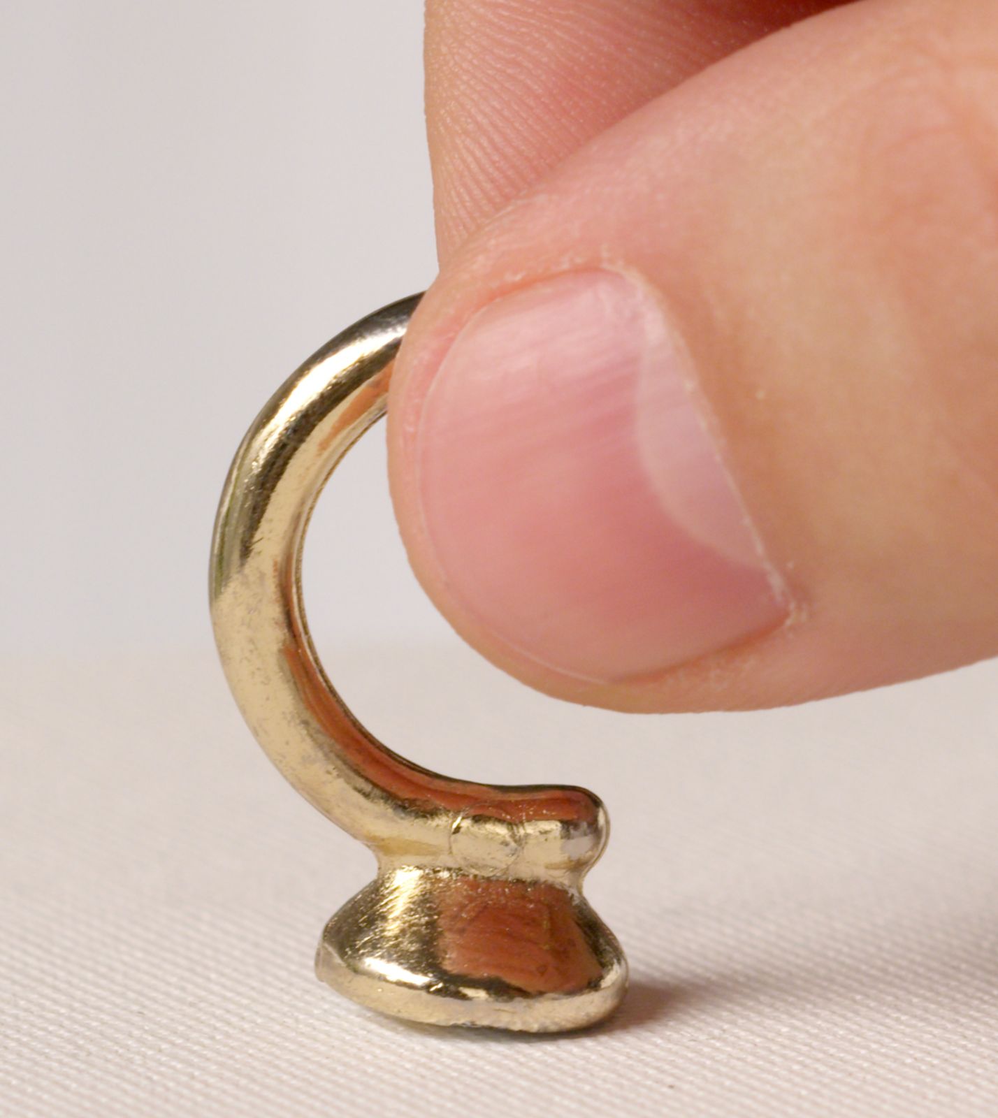 Close-up of a small gold hook for a hanging tray