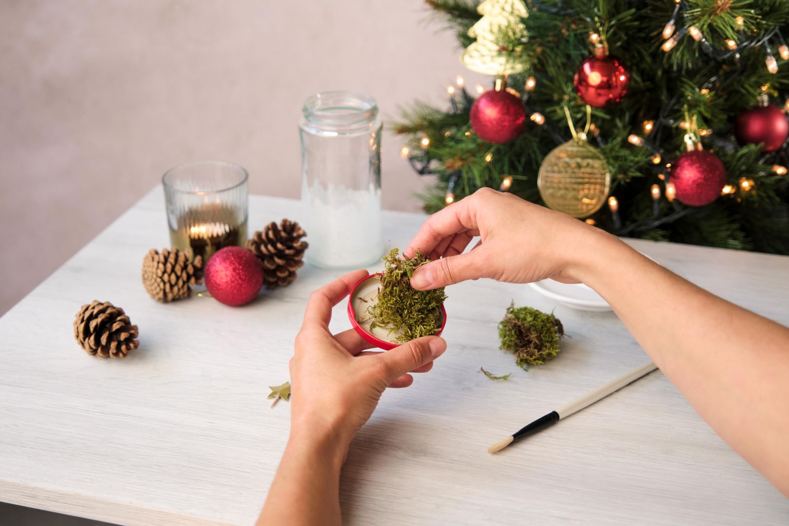 Attaching green moss to a red jar lid base