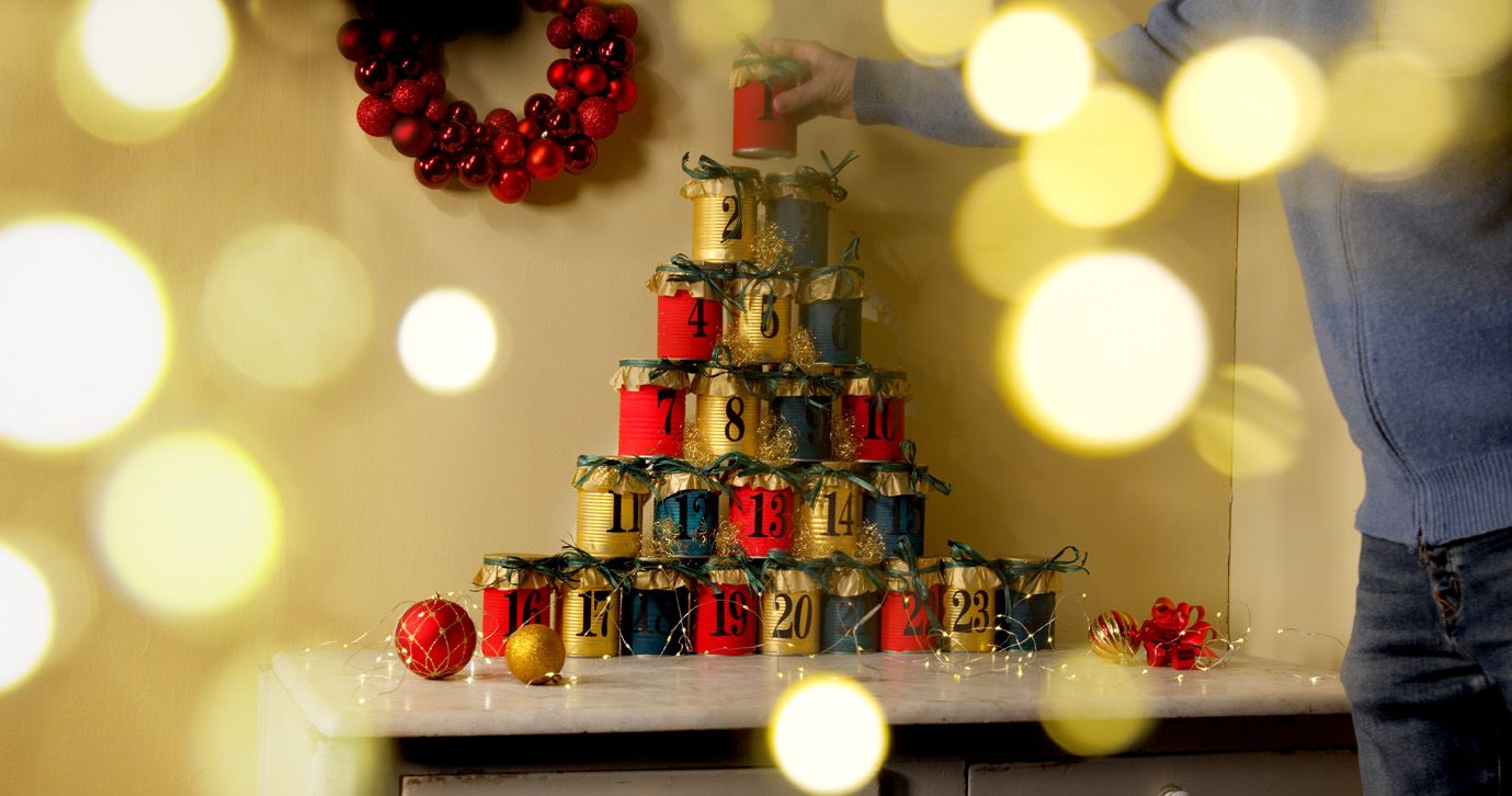 Pyramid of painted Mutti cans forming a Christmas advent calendar
