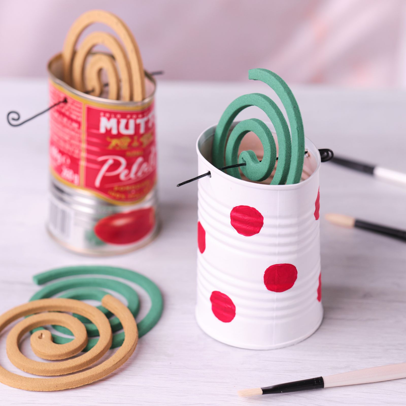 Finished mosquito coil holder made from a painted Mutti Pelati can