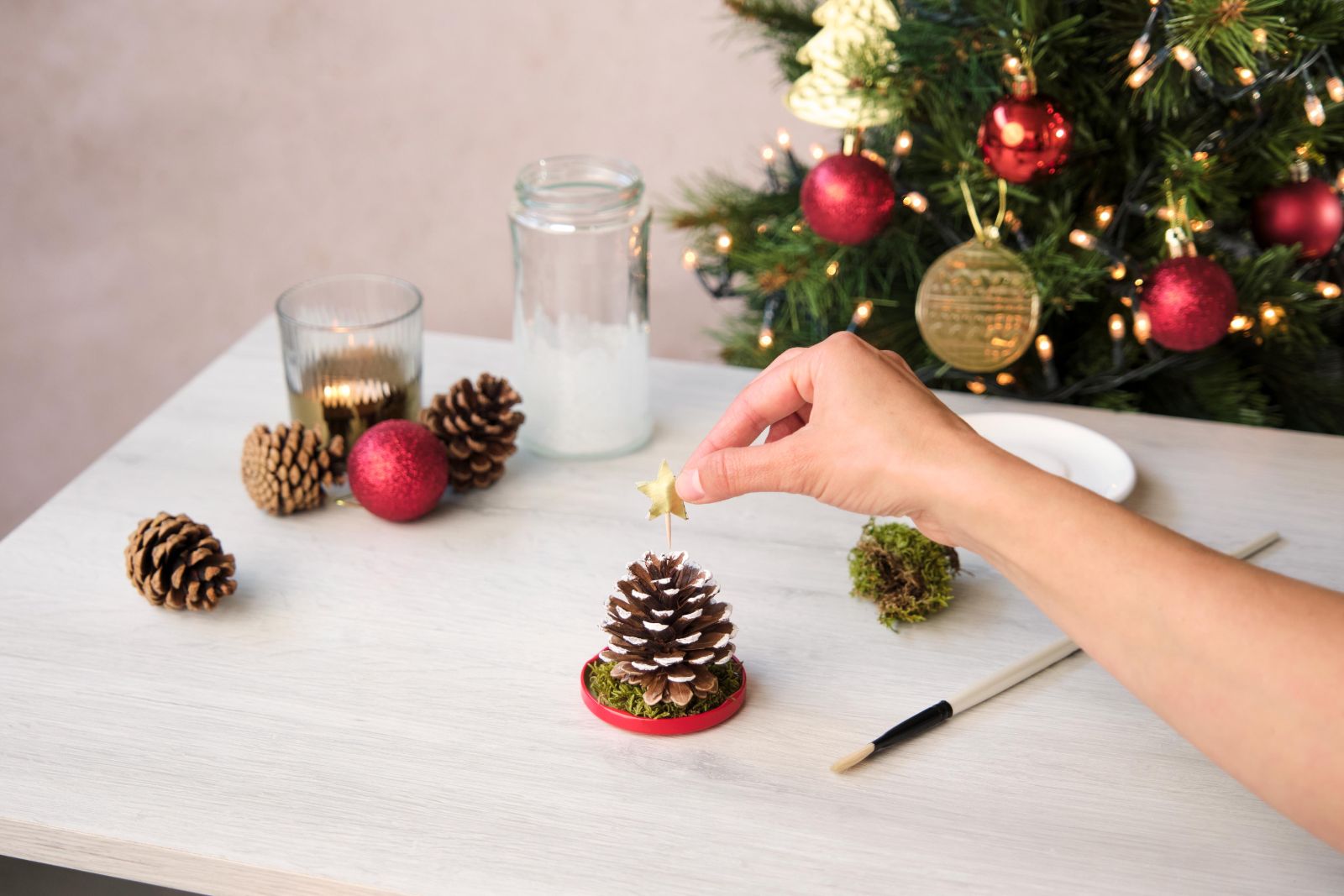 Adding a small gold star to the top of a pinecone tree