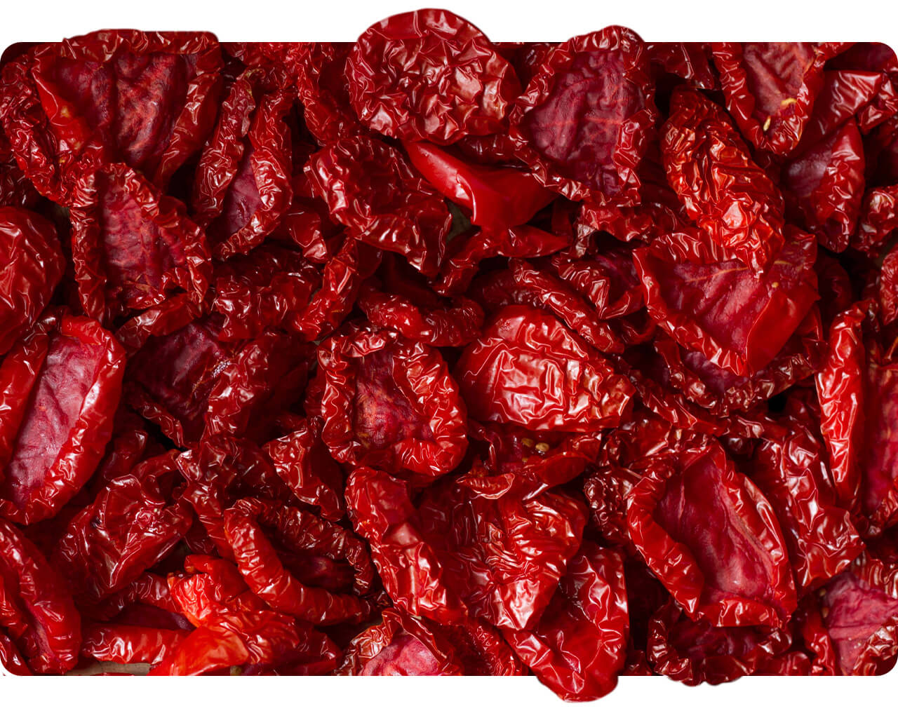 Pile of dark red sun-dried tomato pieces
