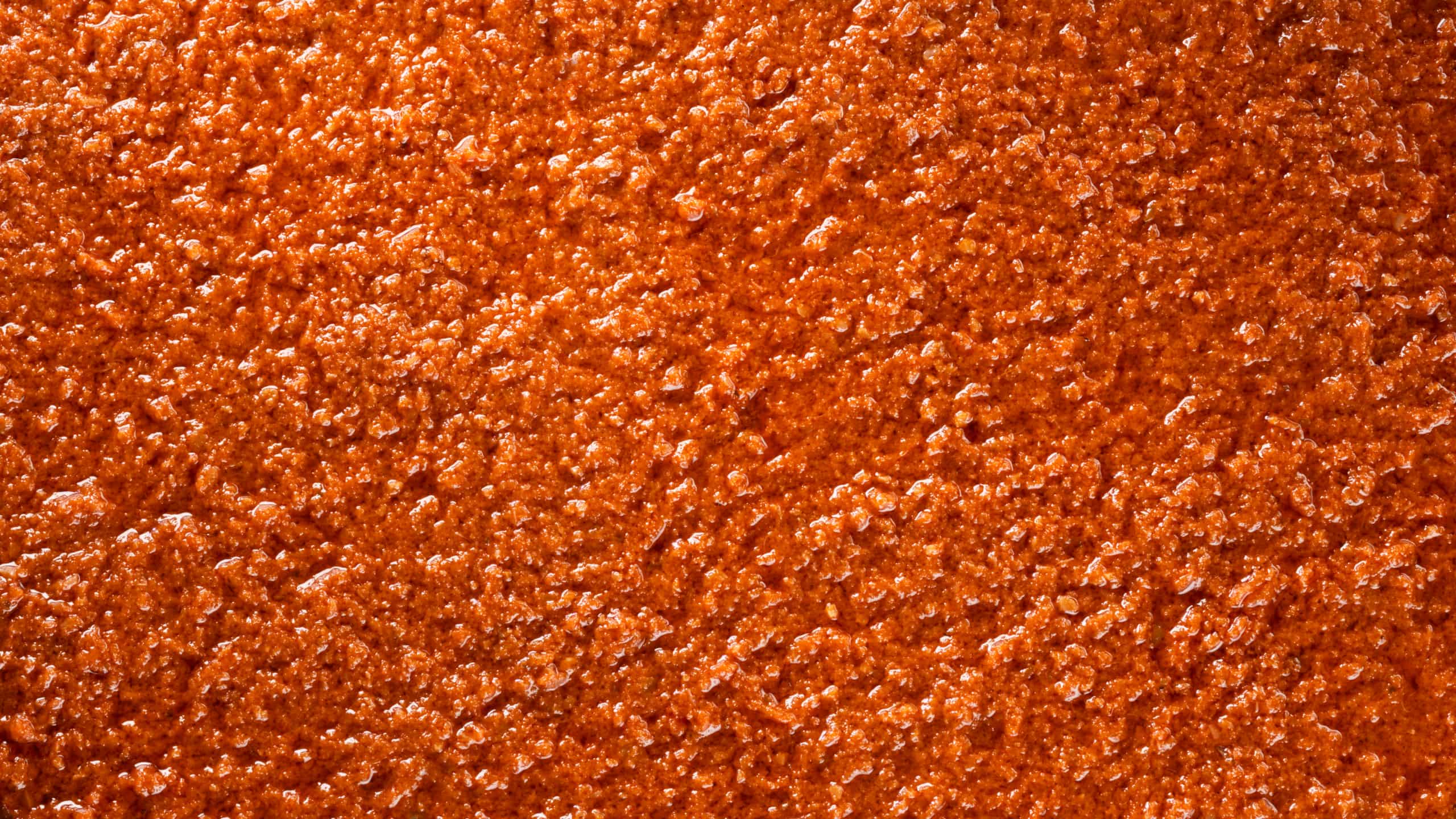 Close-up granular texture of Mutti red tomato pesto