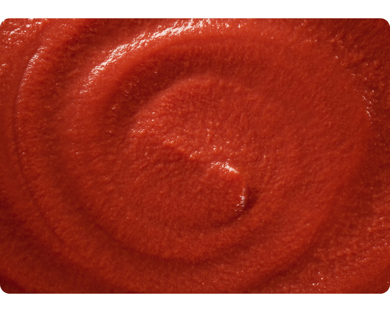 Close-up swirl texture of smooth tomato puree