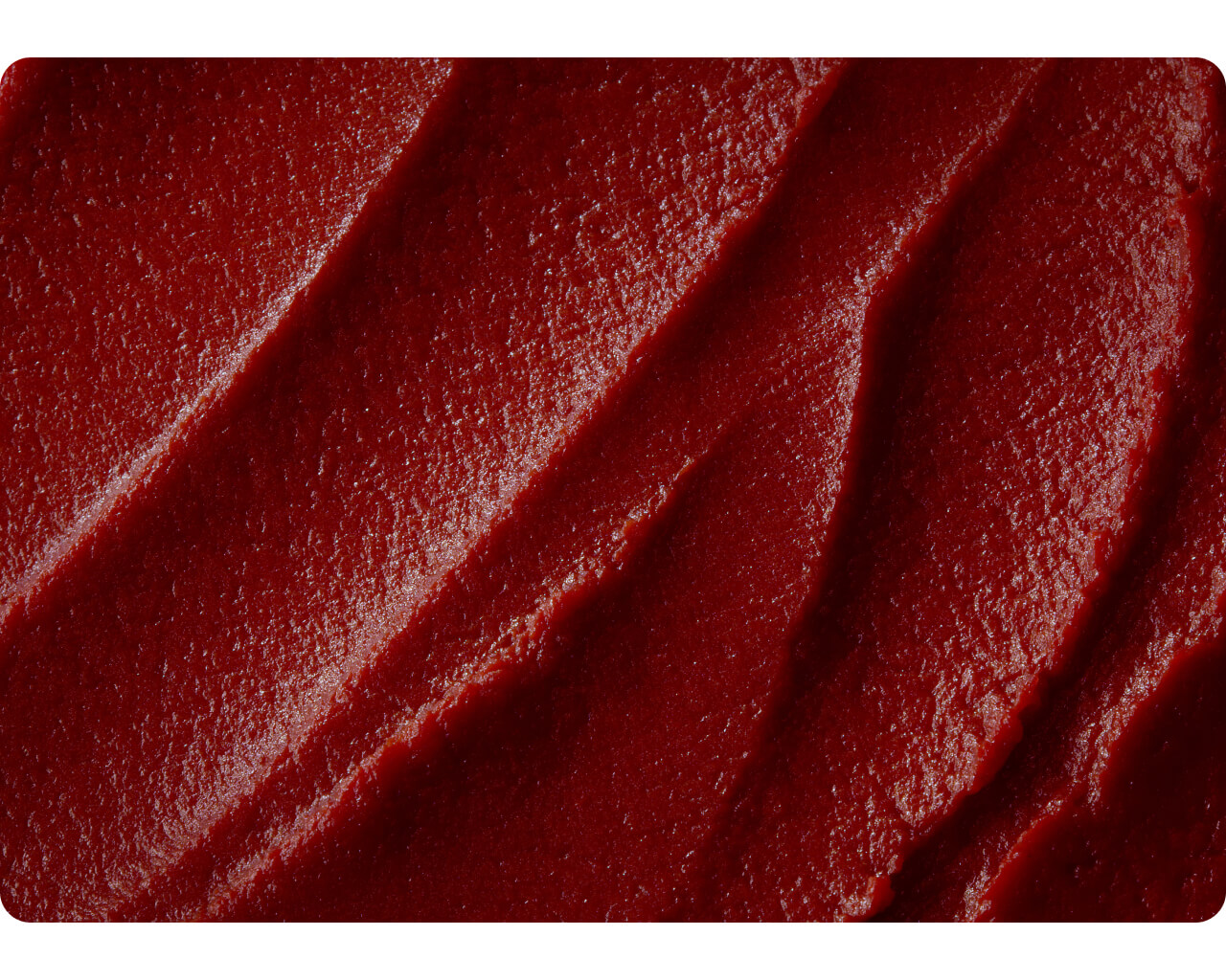 Close-up texture of dark triple concentrated tomato paste