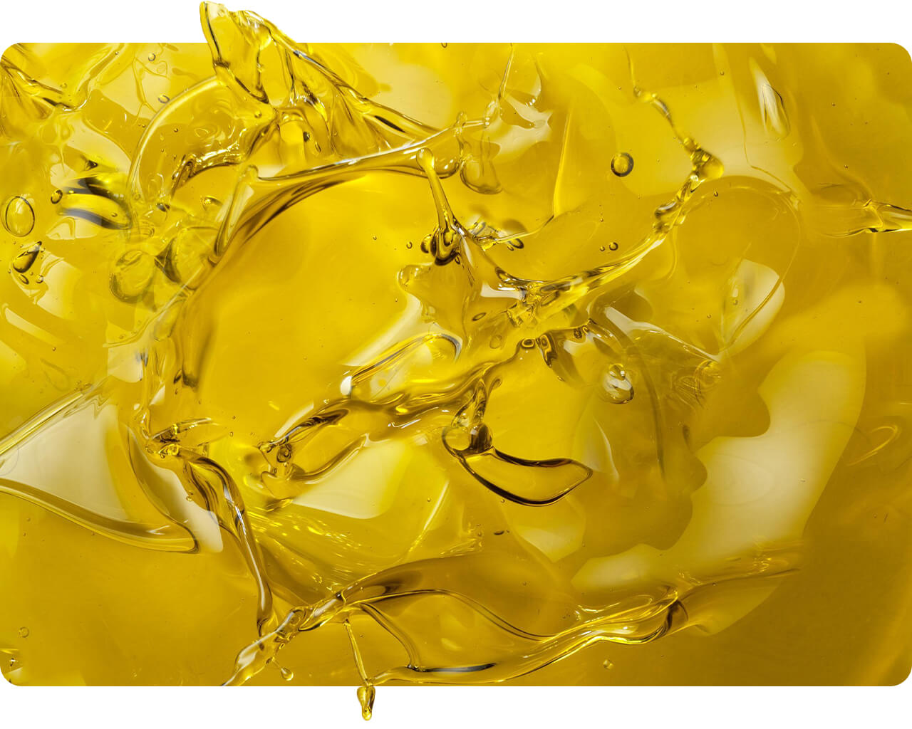 Swirling ribbon of golden olive oil close-up